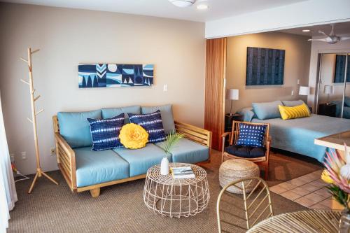a living room with a couch and a bed at Napili Village Hotel in Kahana