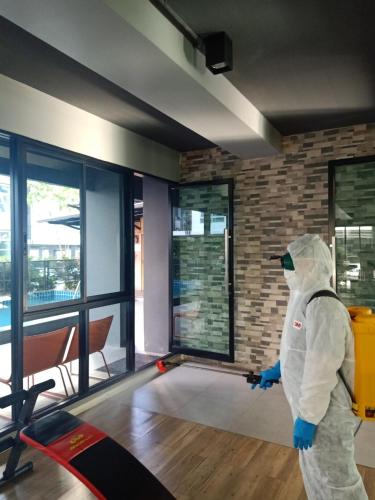 a person in a room with a roombreaking sidx sidx at Interpark Hotel & Residence, Eastern Seaboard Rayong in Ban Phan Sadet Nok
