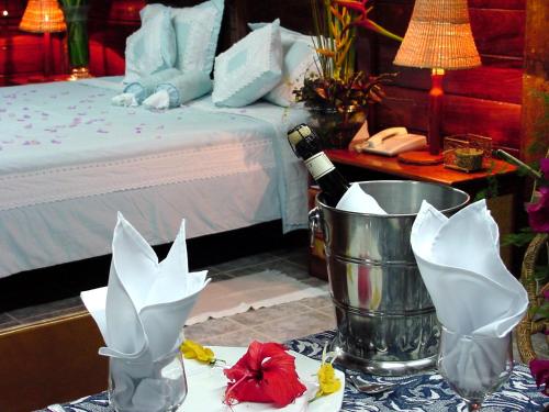 a bedroom with a bed and a table with a bottle of champagne at Ceta Ecotel in Macapá