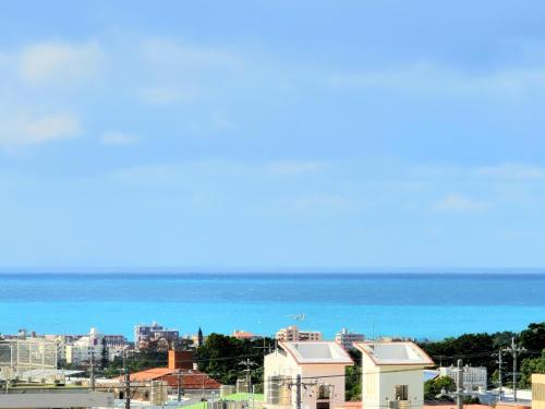 a view of the ocean and a city at "沖縄の美ら海をイメージしたコンセプトルーム, 100インチスクリーン&,プロジェクターで映画三昧!, ゆったり64平米2LDK" Villa Blu Okinawa Chatan 3-3 ヴィラブルー沖縄北谷3-3 in Chatan