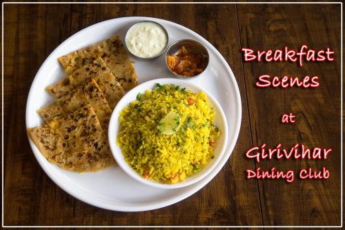 a plate of food with rice and bread and dips at Girivihar Holiday Club - Pure Veg in Lonavala