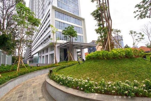 a walkway in front of a tall building at Menteng Park Exclusive Emerald in Jakarta