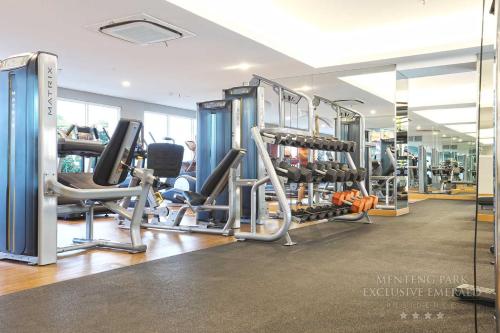 a gym with lots of treadmills and machines at Menteng Park Exclusive Emerald in Jakarta
