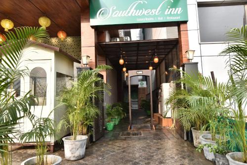 an entrance to a restaurant with potted plants at Southwest Inn - Boutique Hotel in New Delhi