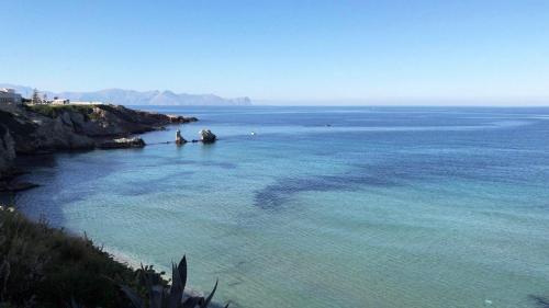 a large body of water with a group of people in it at Amantea Monument in Terrasini