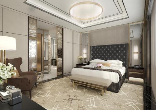 a bedroom with a king sized bed and a chair at Grand Hyatt Al Khobar Hotel and Residences in Al Khobar