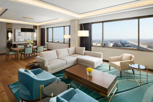 a living room with a couch and chairs and a table at Grand Hyatt Al Khobar Hotel and Residences in Al Khobar