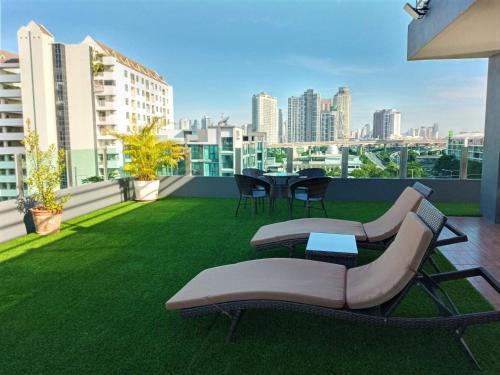 a patio with chairs and tables on a balcony at The Qube fifty Hotel in Bangkok