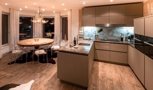 a kitchen with a table and a dining room at Apartmenthaus Mountainvista in Kleinarl