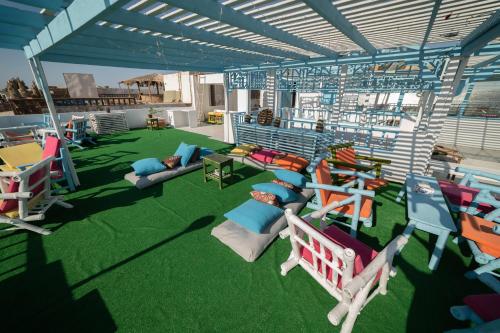 a rendering of a patio with chairs and tables at Bamboo House Hotel Dahab in Dahab