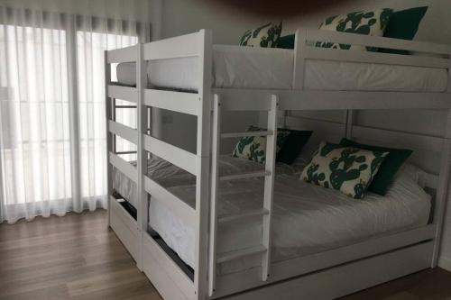 a white bunk bed in a room with at Villa das Hortas - modern villa at Silvercoast - Portugal in Salir do Porto
