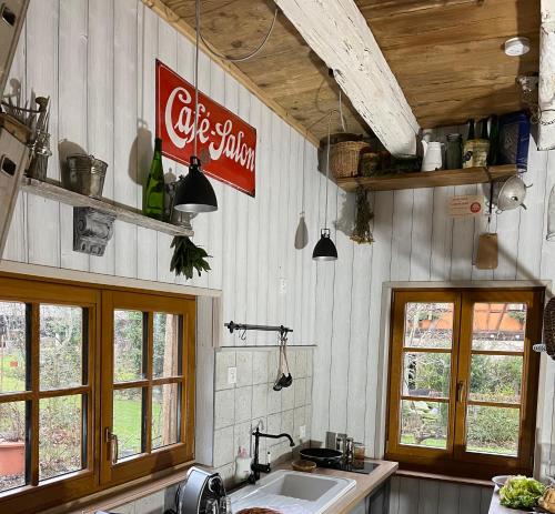 a kitchen with a cocacola sign on the wall at La Ferme de Marie in Rangen