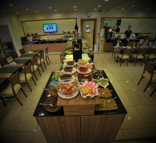 a buffet line with food on it in a restaurant at Hotel Helen Park in Canakkale