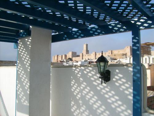 a light on a wall with a view of a city at Dar Baaziz in Sousse