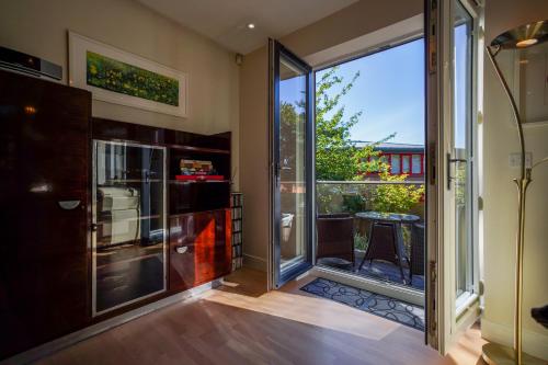 a kitchen with a sliding glass door with a balcony at Royal Stuart Lane - Townhouse by the Bay with Parking in Cardiff