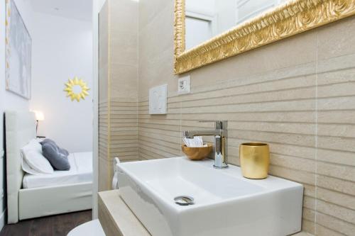 a bathroom with a white sink and a mirror at Rhoome Holiday in Rome