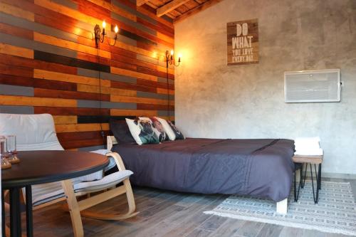 a bedroom with a bed and a table and a tableablish at Palheiro do Malgas in Lousã