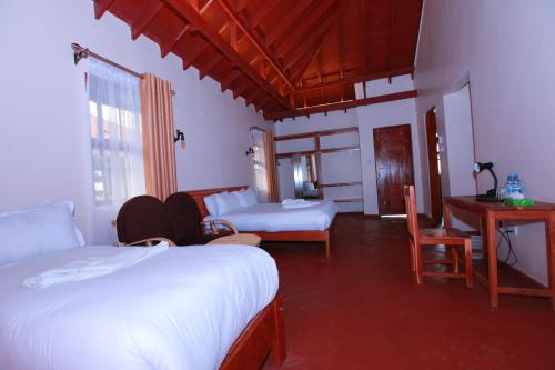 Postel nebo postele na pokoji v ubytování Mtoni Resort, Naro moru