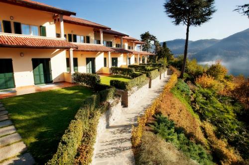 a house with a garden in front of it at TREMEZZO RESIDENCE 5-1 of 11 apartments in an exclusive residence by Italian Apartments in Tremezzo
