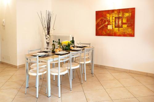 a dining room table with chairs and a painting on the wall at TREMEZZO RESIDENCE 5-1 of 11 apartments in an exclusive residence by Italian Apartments in Tremezzo