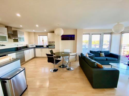 a living room with a couch and a table at Basingstoke Central Apartments in Basingstoke