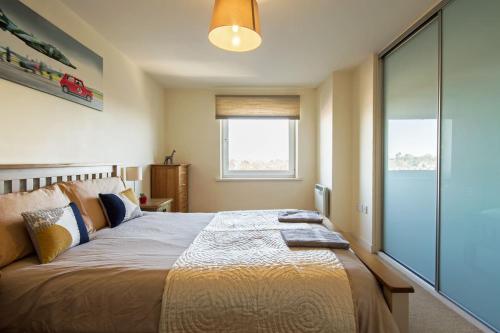 a bedroom with a large bed and a window at Basingstoke Central Apartments in Basingstoke