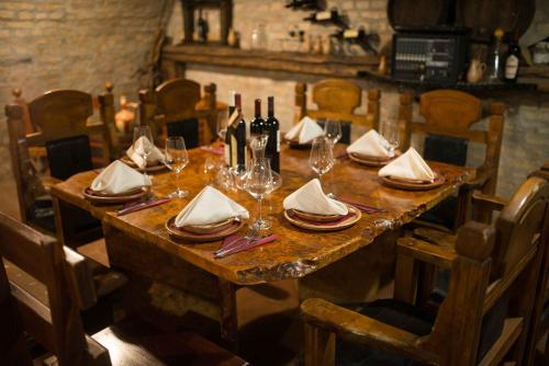 a wooden table with wine glasses and napkins on it at Vila Prezident in Sremski Karlovci