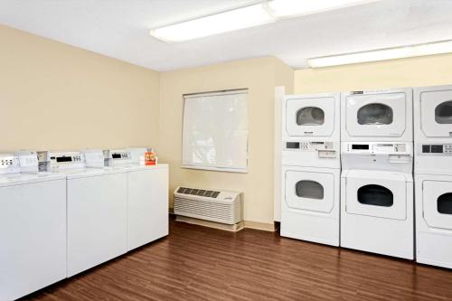 a room with four washing machines and a window at MainStay Suites Chicago Hoffman Estates in Hoffman Estates