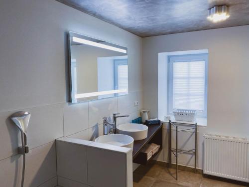 een witte badkamer met een wastafel en een spiegel bij Ebners Träumerei in Winklern