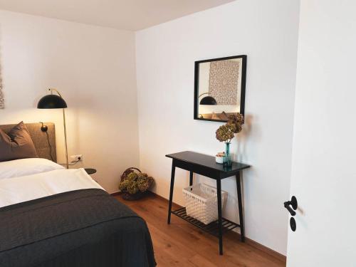 a bedroom with a bed and a table with a mirror at Ebners Träumerei in Winklern