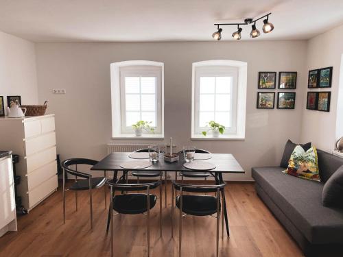 a living room with a table and chairs and a couch at Ebners Träumerei in Winklern