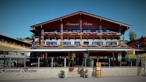 a large building with flowers on top of it at Café-Restaurant Bettina in Ellmau