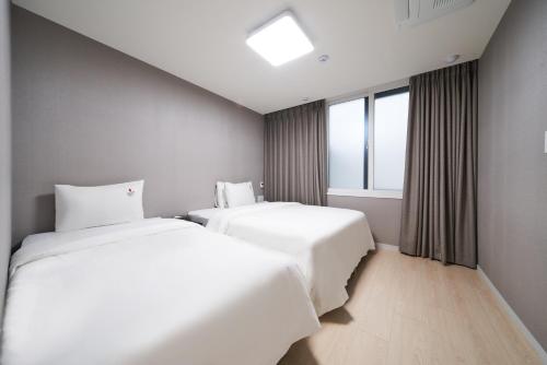Ένα ή περισσότερα κρεβάτια σε δωμάτιο στο BON Hotel BUSINESS
