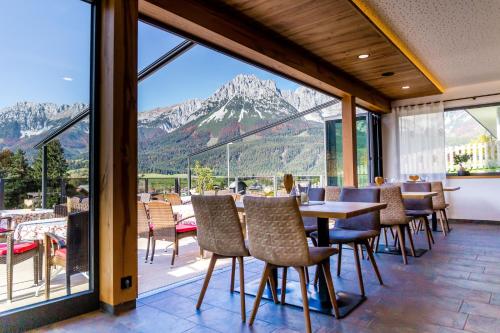 a restaurant with a view of the mountains at Café-Restaurant Bettina in Ellmau