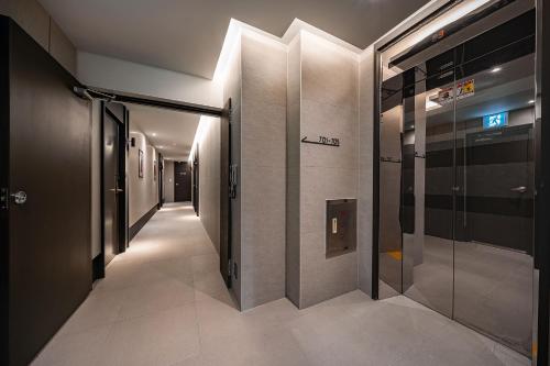 a hallway of a building with a glass door at Brown Dot Hotel Signature in Busan