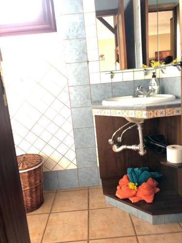 a bathroom with a sink and a counter with towels at Casa Cueva de las Palomas 2 in Las Manchas
