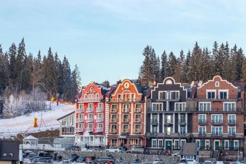 a group of buildings in front of a ski resort at Petros Hotel in Bukovel
