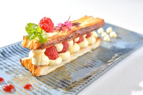 a sandwich with fruit on top of a plate at Gite du Clos Champagnac in Chailly-sur-Armançon