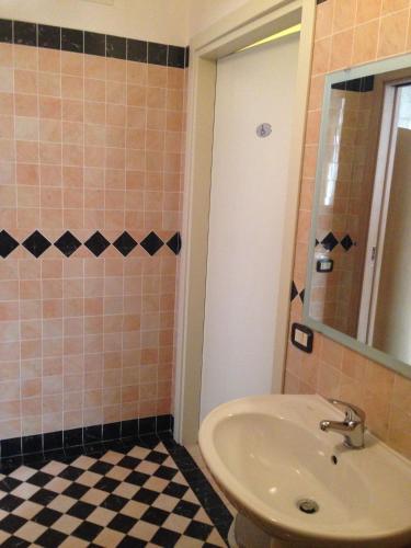 a bathroom with a sink and a mirror at Hotel Cristal Eboli in Eboli