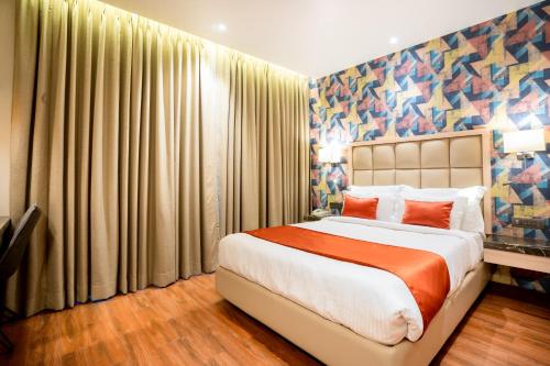 a bedroom with a large bed in a room at The Orchid Lonavala in Lonavala