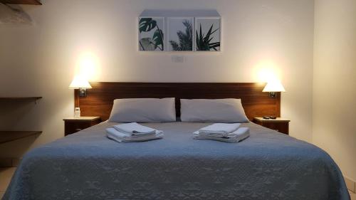 Ліжко або ліжка в номері Pousada Vale do Dinossauro