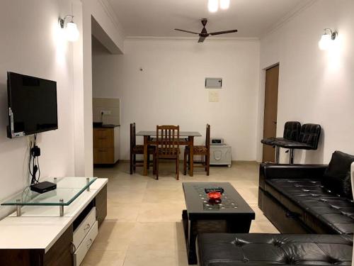 a living room with a couch and a table at Sunshine in Old Goa
