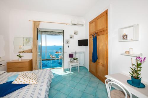 a bedroom with a bed and a view of the ocean at Casa Gilda Positano in Positano
