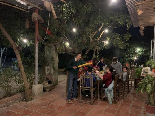 a man holding a baseball bat at a restaurant at Tuan Nam Homestay in Ninh Binh