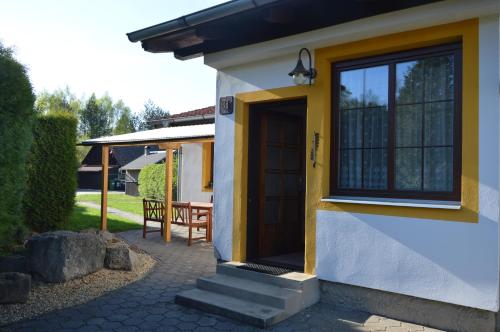 a small house with a door and a patio at Chalupa na Koskách in Třeboň