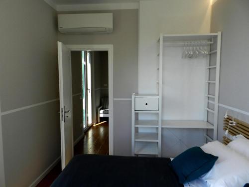 a bedroom with a bed and a book shelf at ARIA DI MARE, Manarola - Appartamento THE VIEW in Manarola