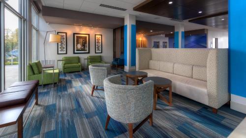 a waiting room with a couch and chairs at Holiday Inn Express & Suites Tulsa Midtown by IHG in Tulsa