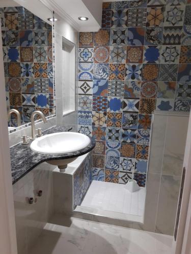 a bathroom with a sink and a shower at Radar Mirador Cabo Corrientes in Mar del Plata