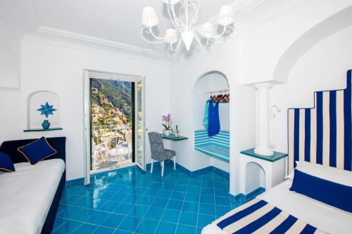 a bedroom with blue tile flooring and a bed at Hotel Reginella in Positano