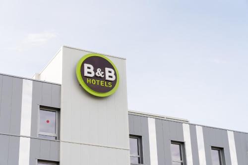 a bbc hotel sign on the side of a building at B&B HOTEL Poitiers Aéroport in Poitiers